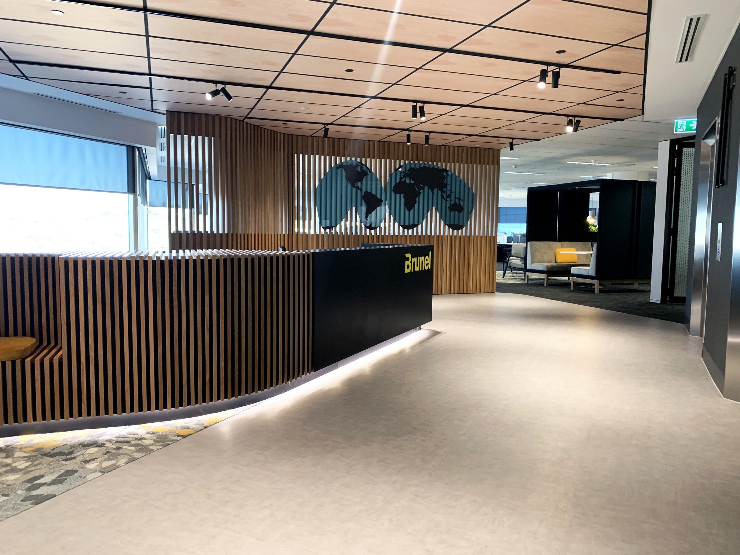 Wood reception desk with global map beyond
