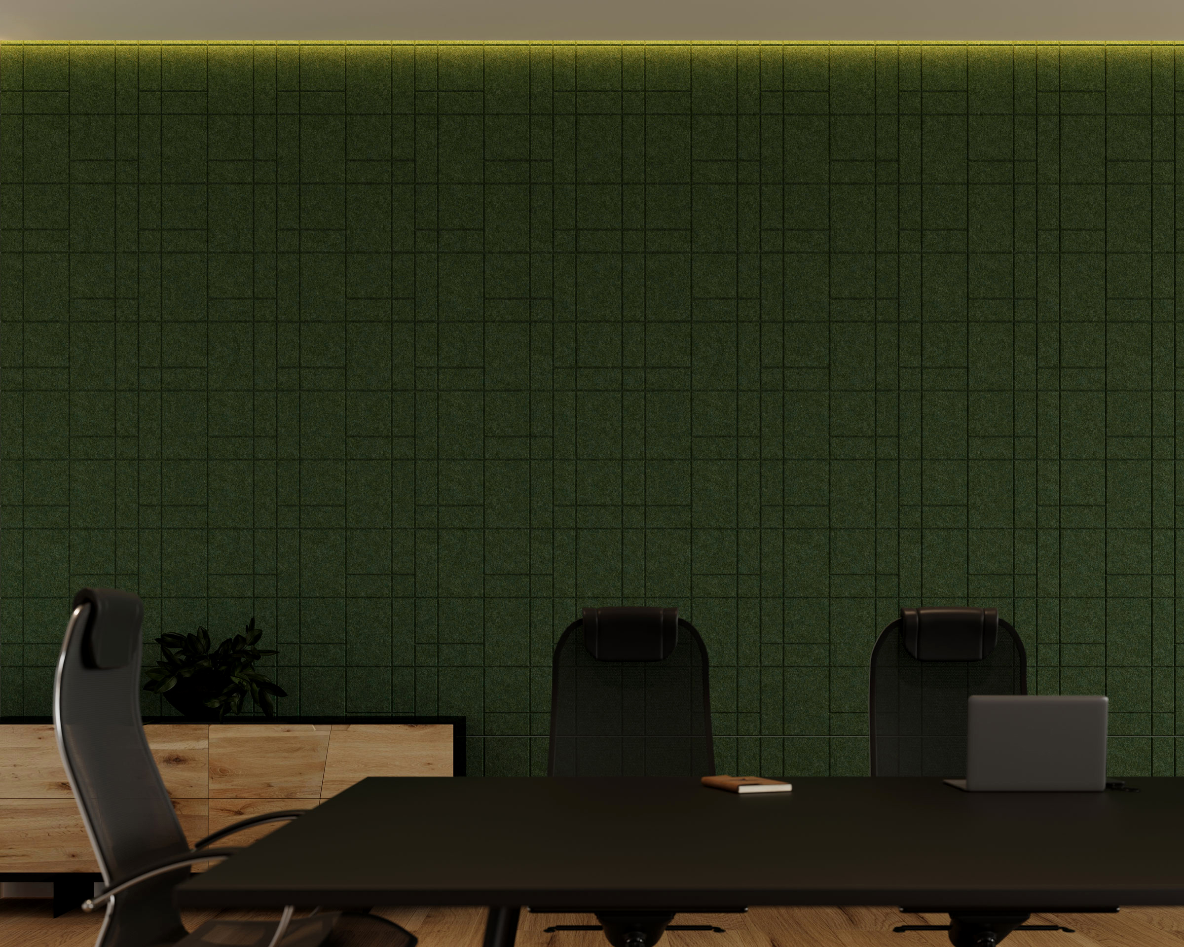 A minimalist conference room with a dark green grid-patterned wall and acoustic felt wall tiles, a black conference table, and black chairs. A laptop and a notepad are on the table. A wooden cabinet with a plant is against the wall. Subtle overhead lighting illuminates the room.