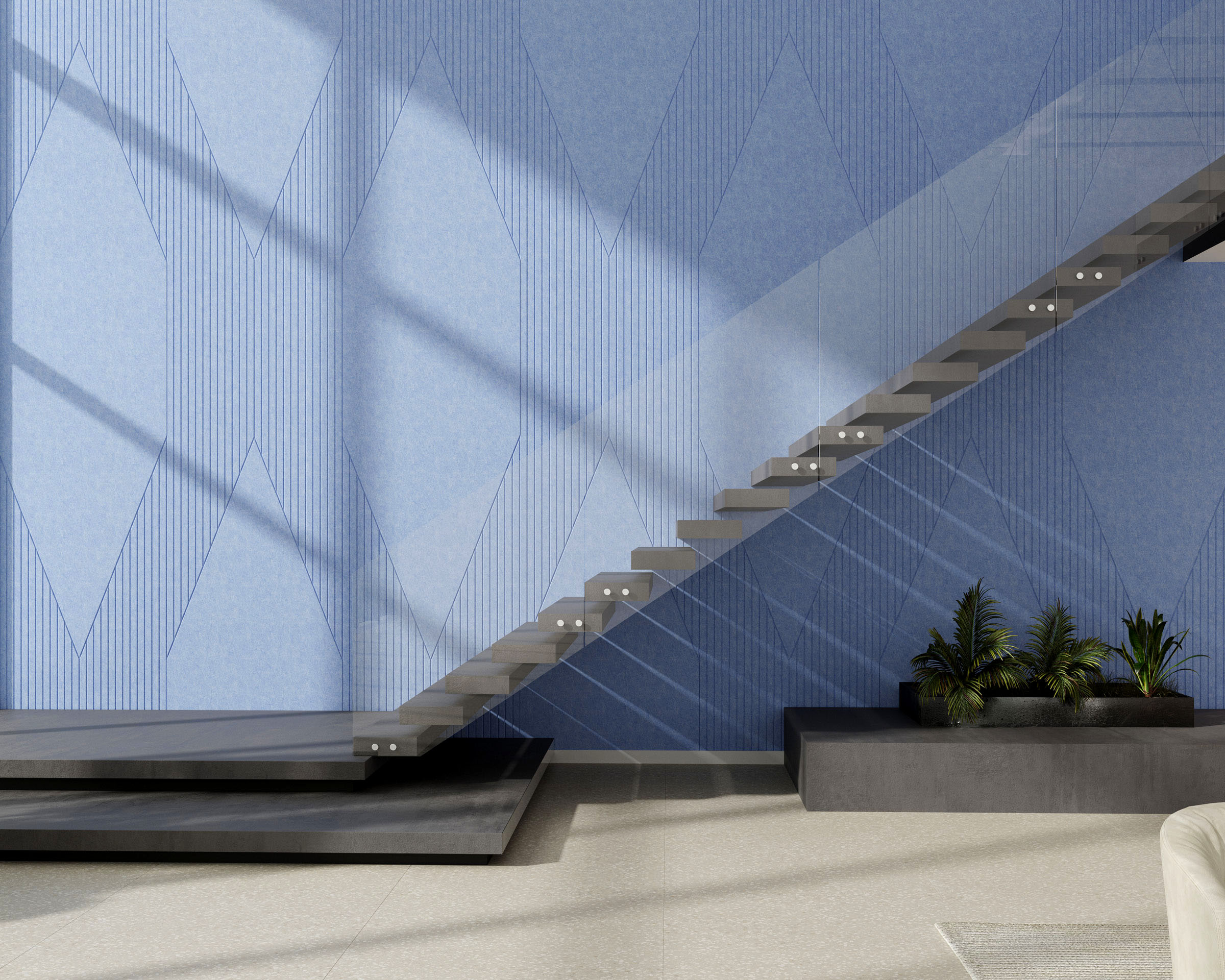 A modern, minimalist indoor staircase with floating concrete steps and a glass railing. The wall beside the stairs features acoustic felt wall panels in a geometric blue pattern, and a set of green plants in black planters is placed near the base of the stairs.