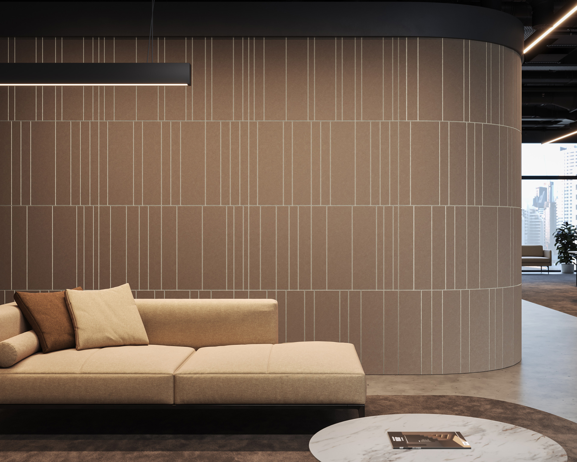 A modern office interior features a beige sectional sofa with matching pillows against a curved, textured acoustic felt wall panel with vertical lines. Overhead lighting and a round marble-topped coffee table add to the minimalistic décor. Large windows in the background allow natural light.
