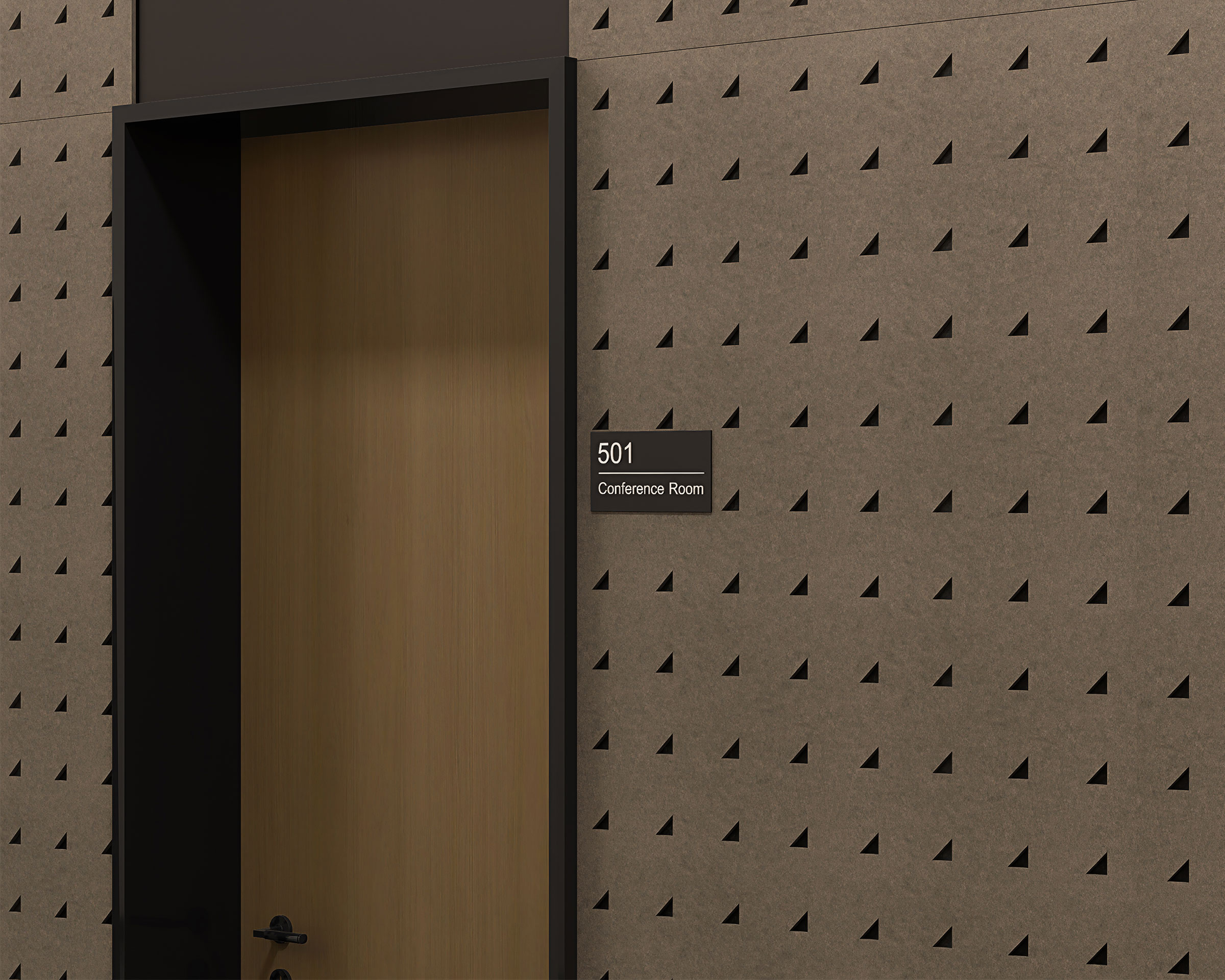 A light wooden door labeled "501 Conference Room" is set in a wall featuring right triangle acoustic felt panels with a modern design. The door frame is dark, contrasting with the wall and door. The signage is black with white text.