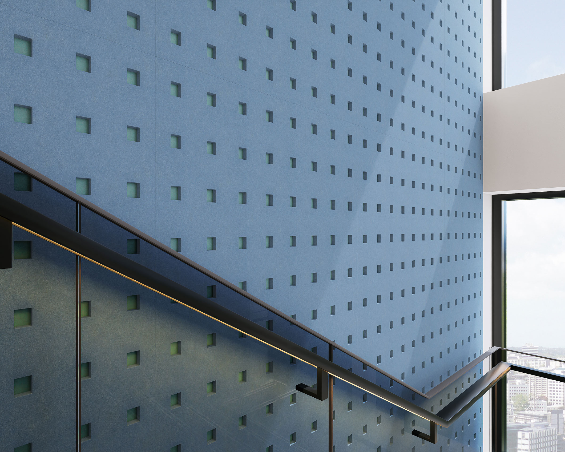 A modern staircase with a sleek, minimalist design features a metal handrail and glass panels. The adjacent wall is covered in blue square acoustic felt wall panels, adding both style and function. Large windows on the right offer a view of a cityscape under a bright sky.