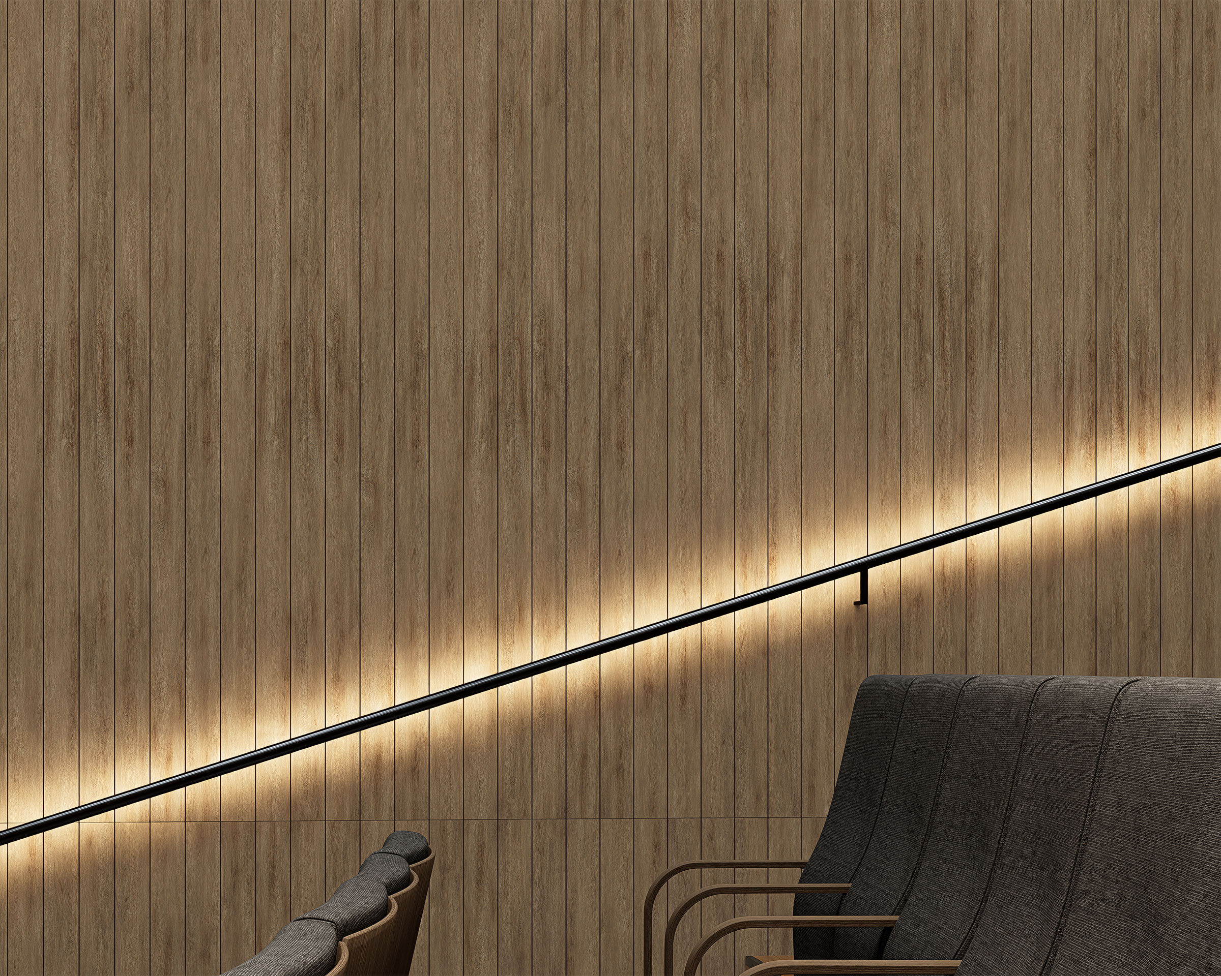 A minimalist interior features a woodgrain acoustic felt slat wall. A black handrail runs diagonally along the wall, illuminated by soft, warm lighting from underneath. Grey fabric chairs with wooden armrests are arranged at the bottom right corner.