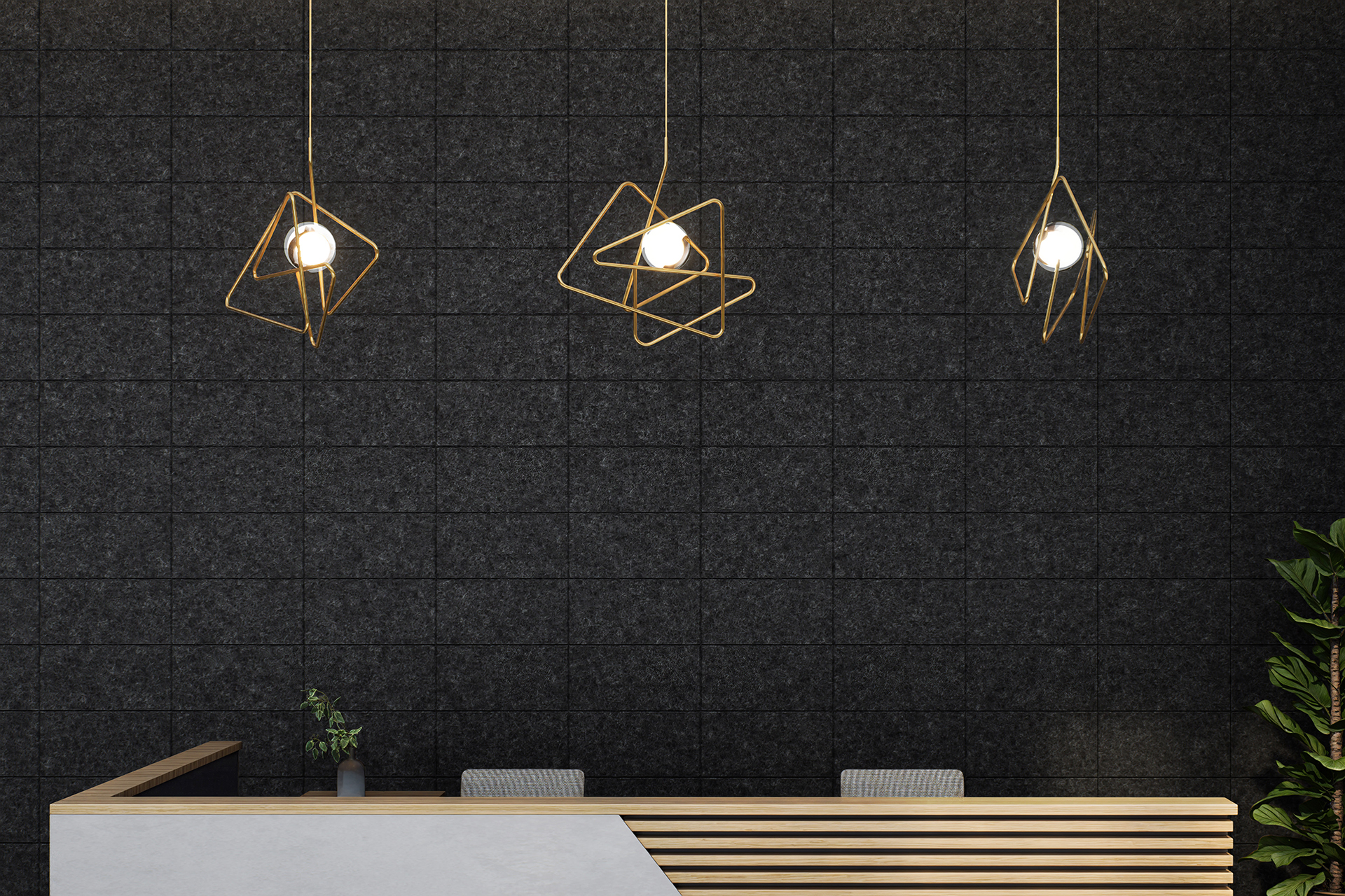 A modern reception area with a wooden desk featuring a diagonal white accent. Above the desk hang three geometric pendant lights with exposed bulbs against a dark textured acoustic felt wall. A small plant sits on the desk, and a tall plant is seen to the right.