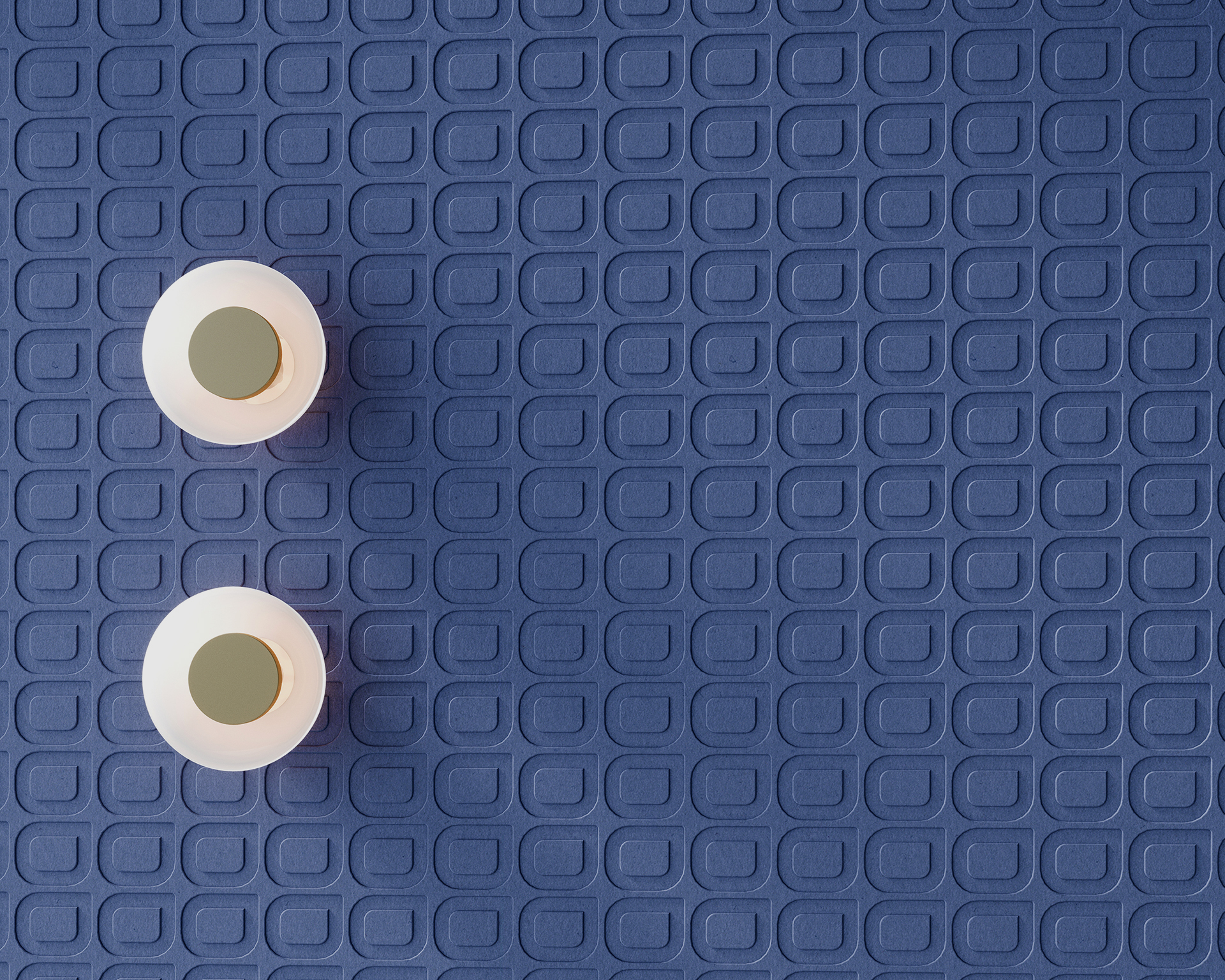 Two white round wall sconces casting light on a textured purple acoustic felt wall with a repeating geometric pattern of raised squares and ovals. The light fixtures are positioned towards the left side of the image.