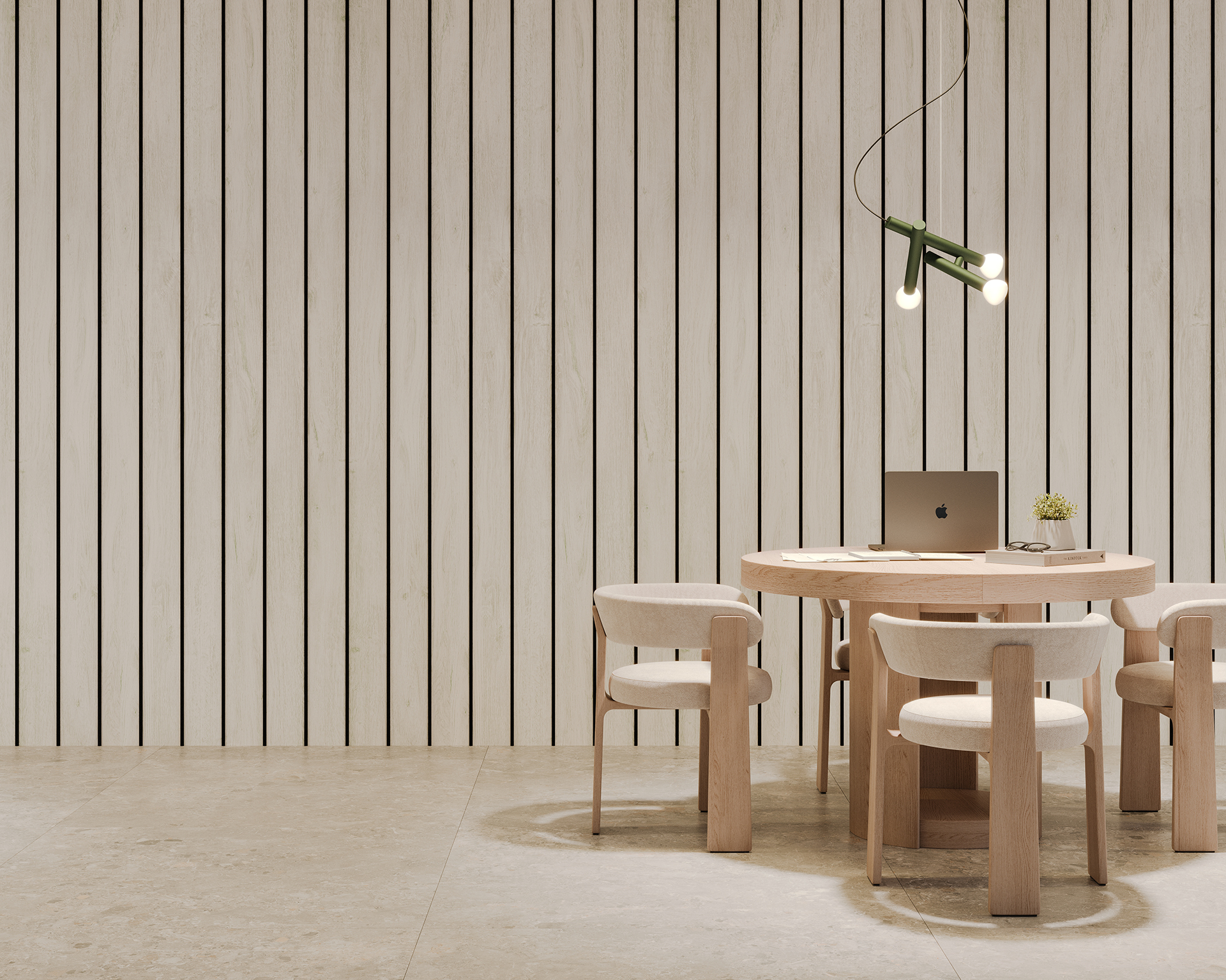 A minimalist room features a round wooden dining table with four matching chairs. A laptop and a small plant sit on the table. The background has vertical woodgrain acoustic felt slats, and a modern pendant light hangs above the table.