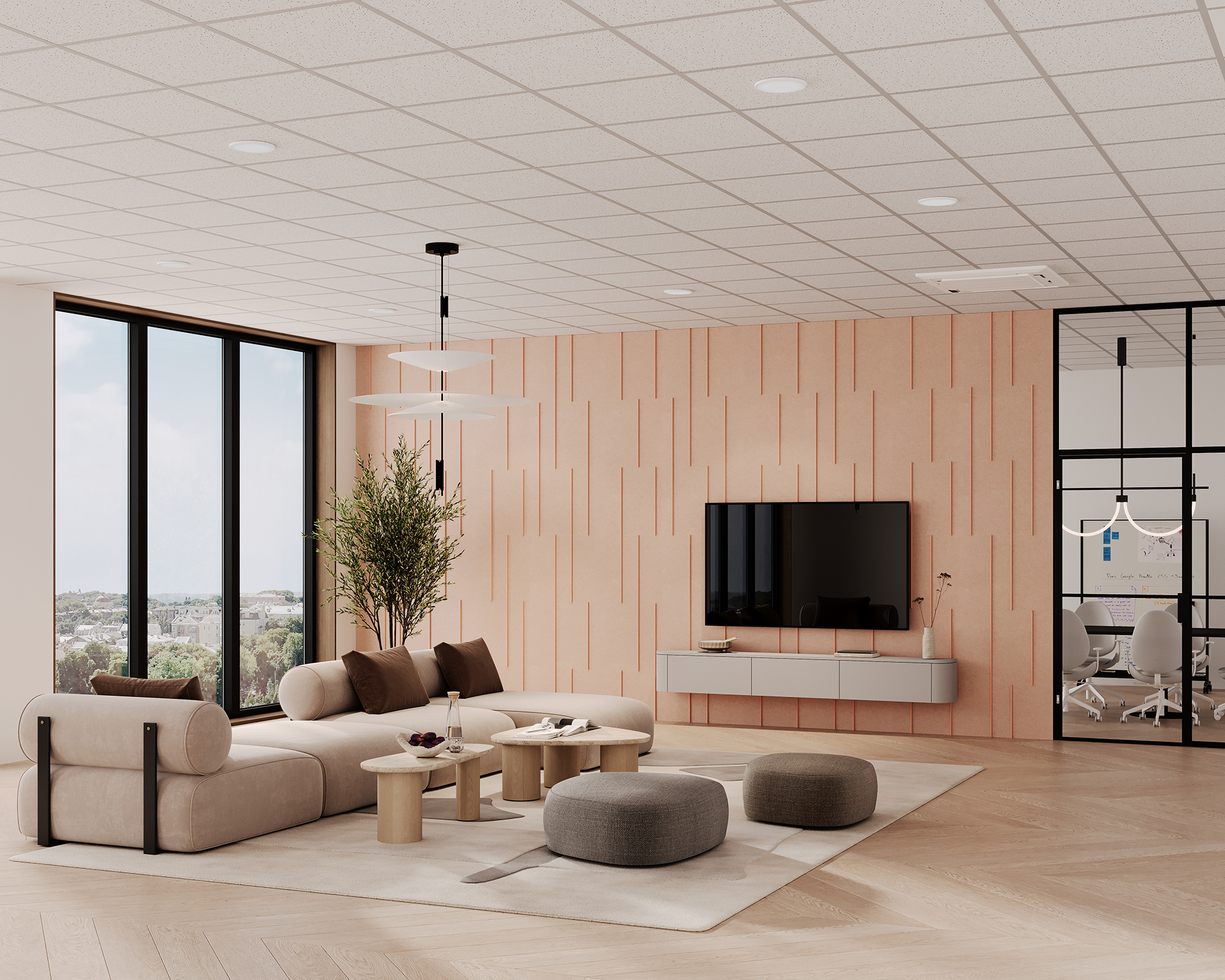 Modern living room with a large window, beige walls, and wood flooring. A flat-screen TV is mounted on the light pink acoustic felt wall. The seating area includes cream sofas, round gray and beige ottomans, and a central coffee table. A potted plant is nearby.