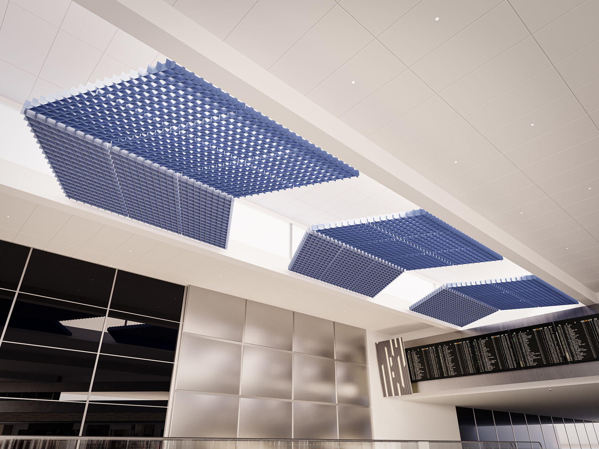 Large blue acoustic felt clouds are suspended from a modern white ceiling above a spacious interior with reflective wall panels, large windows, and a digital information display board.