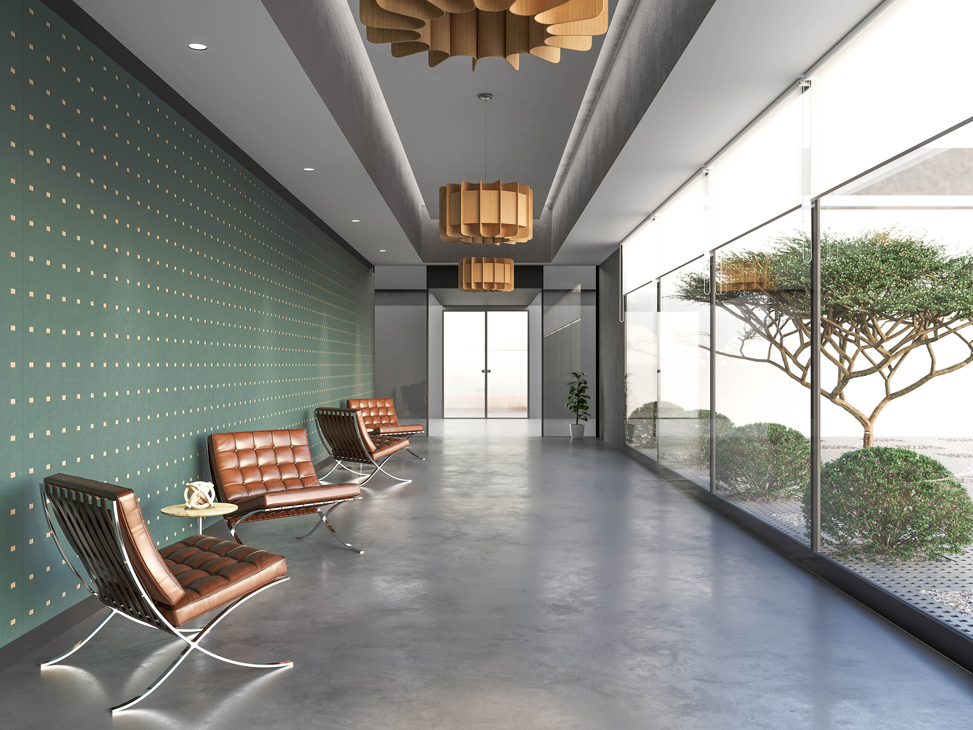 Modern lobby with brown leather chairs, small round tables, and pendant lights. One wall is green acoustic felt with gold rectangle cutouts; the opposite side is glass, showing manicured greenery outside. The floor is polished concrete.
