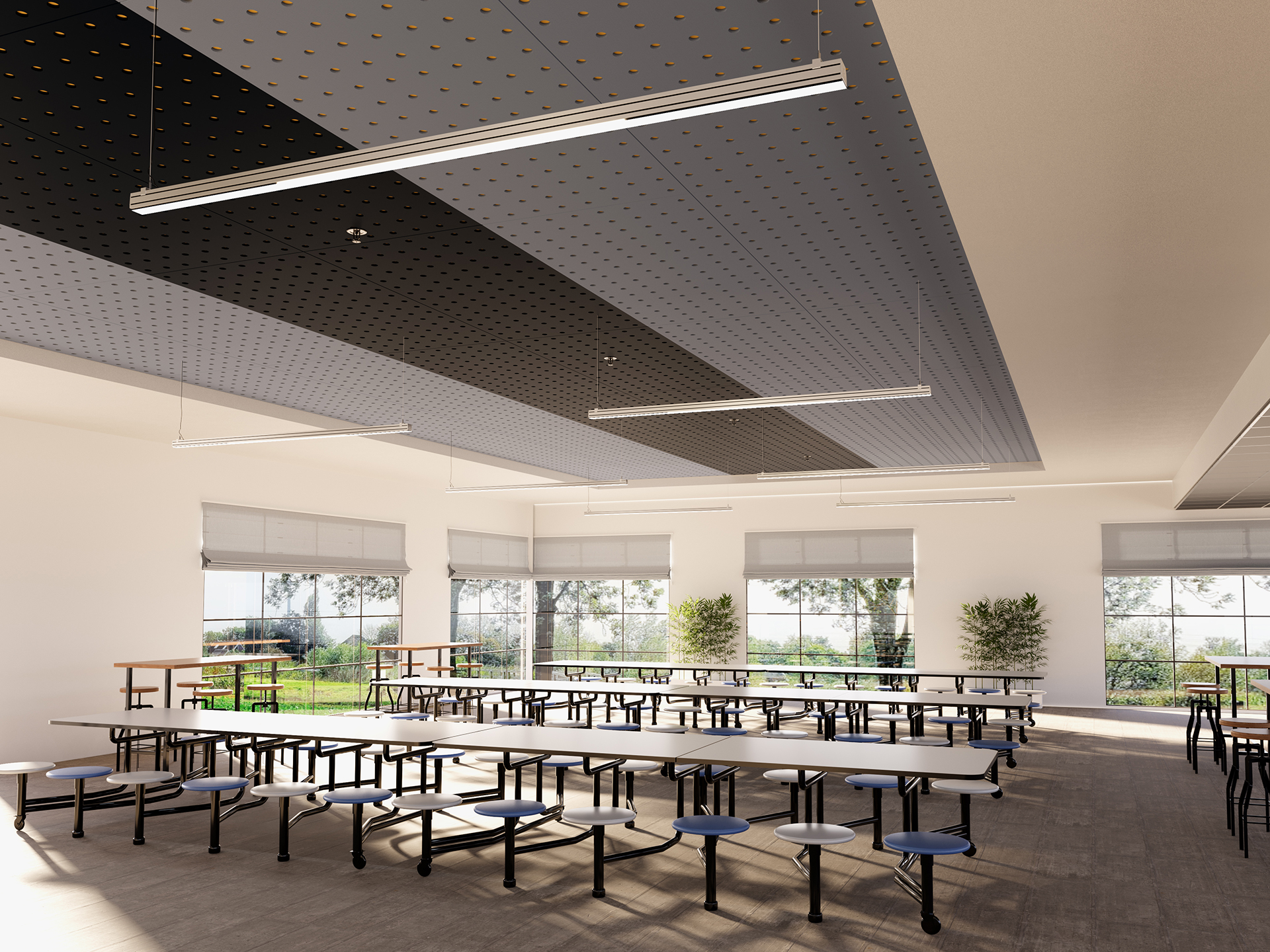 A spacious, well-lit cafeteria with long tables and round stools, large windows letting in natural light, indoor plants, and modern acoustic felt ceiling panels with hanging lights.