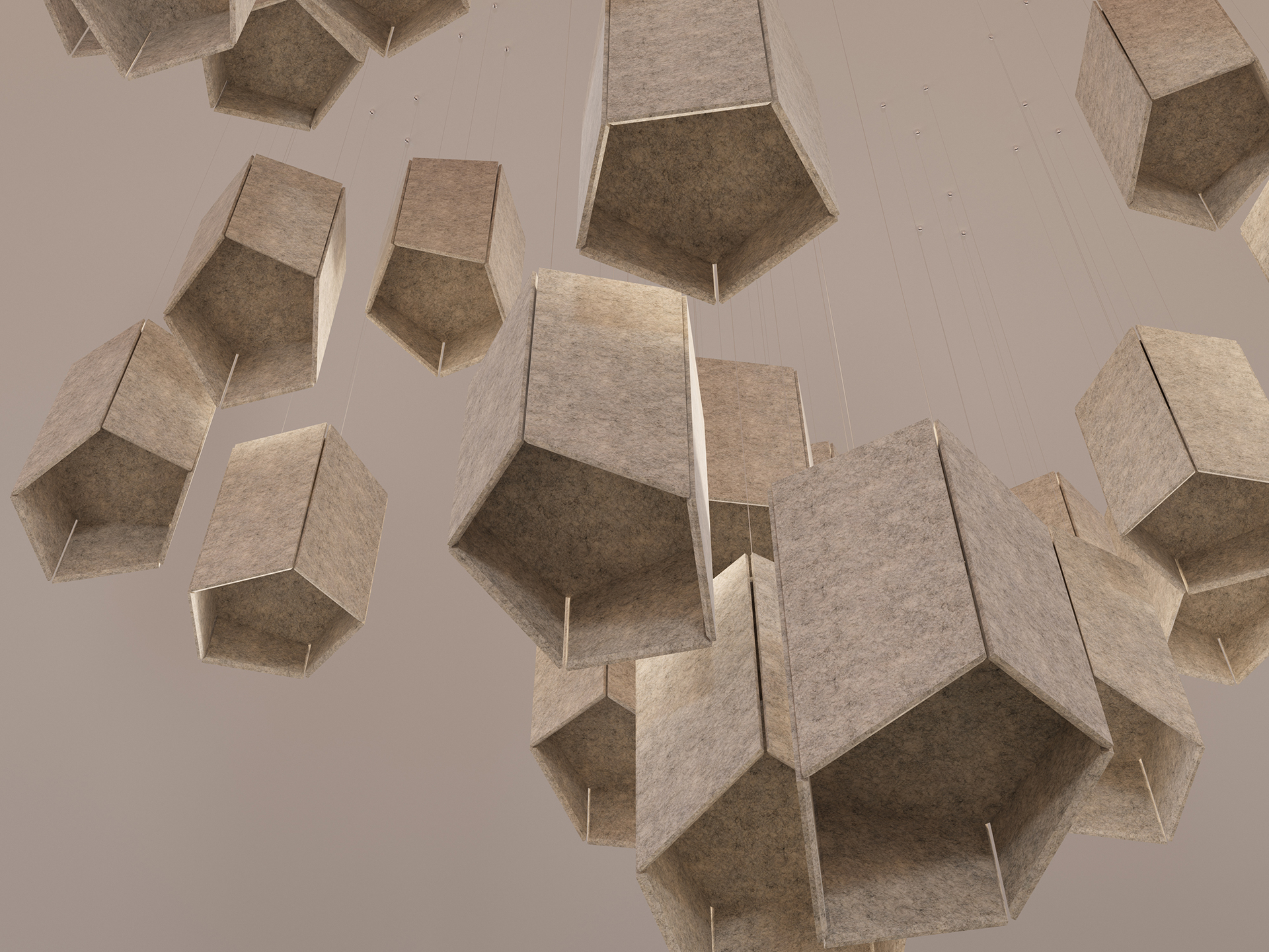 Several large, beige acoustic felt clouds hang from the ceiling on thin wires against a neutral background, creating a geometric, modern art installation.