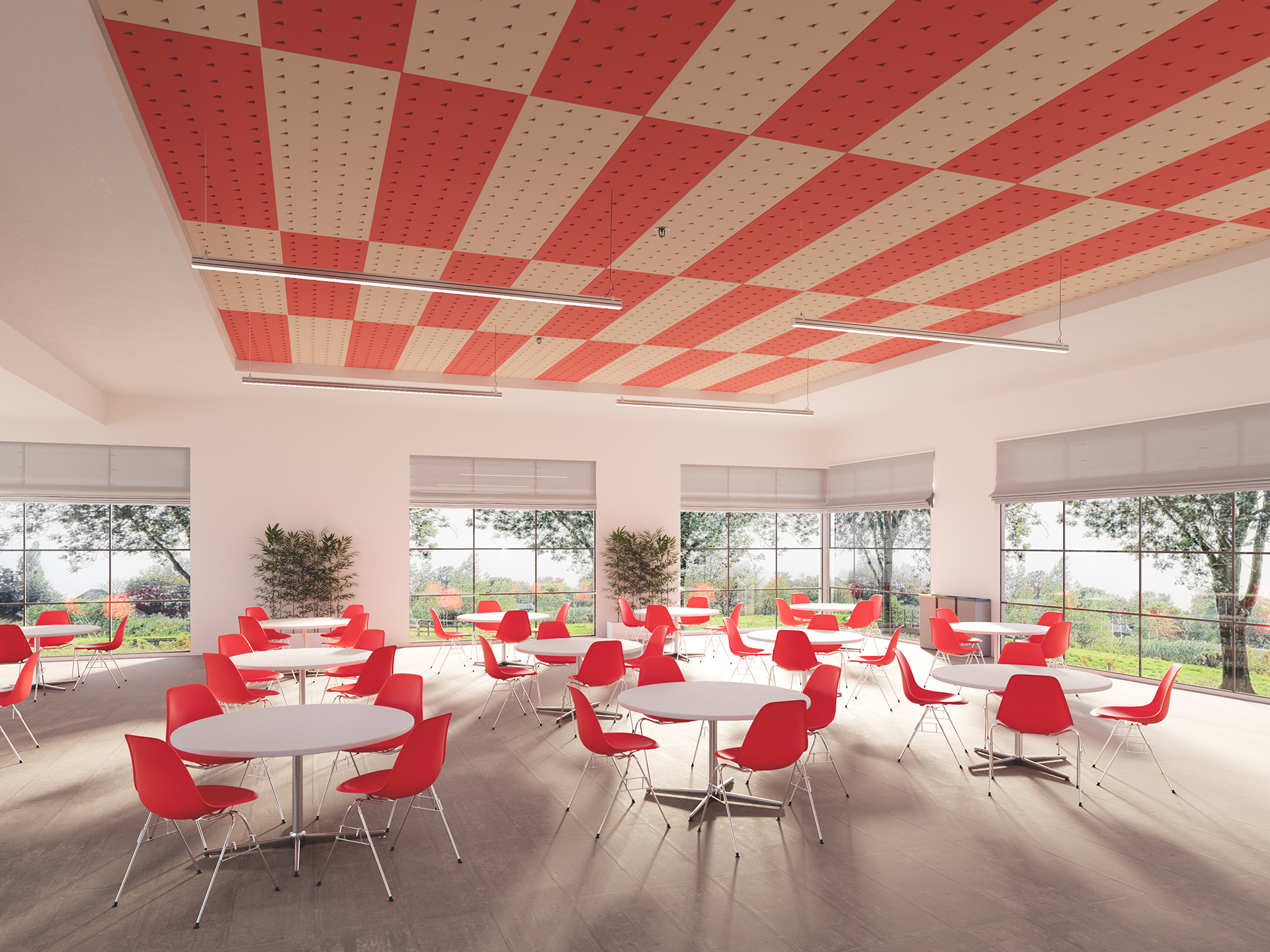 Bright cafeteria with large windows, red and beige checkered acoustic felt ceiling, round white tables, and red chairs. Sunlight streams in, and trees can be seen outside. Two potted plants are in the corners.