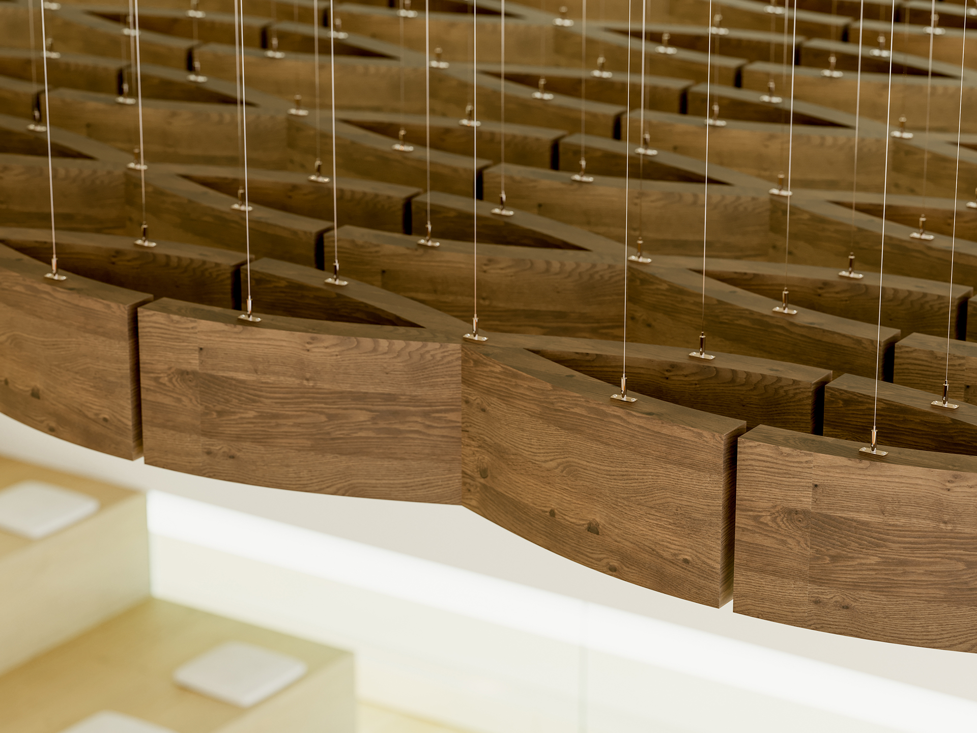 A close-up view of a modern woodgrain acoustic felt ceiling installation with curved, overlapping panels suspended by numerous metal wires in a bright, minimalistic interior space.