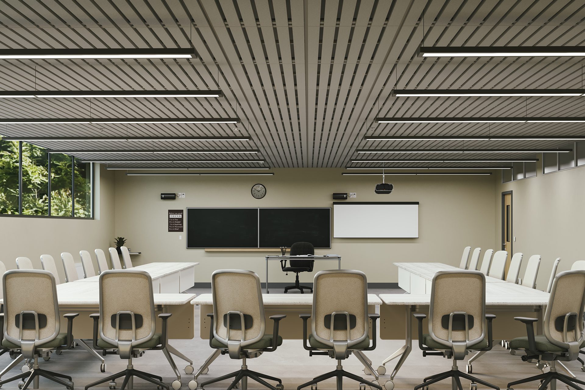 A modern classroom with beige walls, large windows, and rows of beige chairs around white tables facing a blackboard, whiteboard, clock, and teacher’s desk at the front. The room is well-lit with ceiling lights in an acoustic felt slatted ceiling.