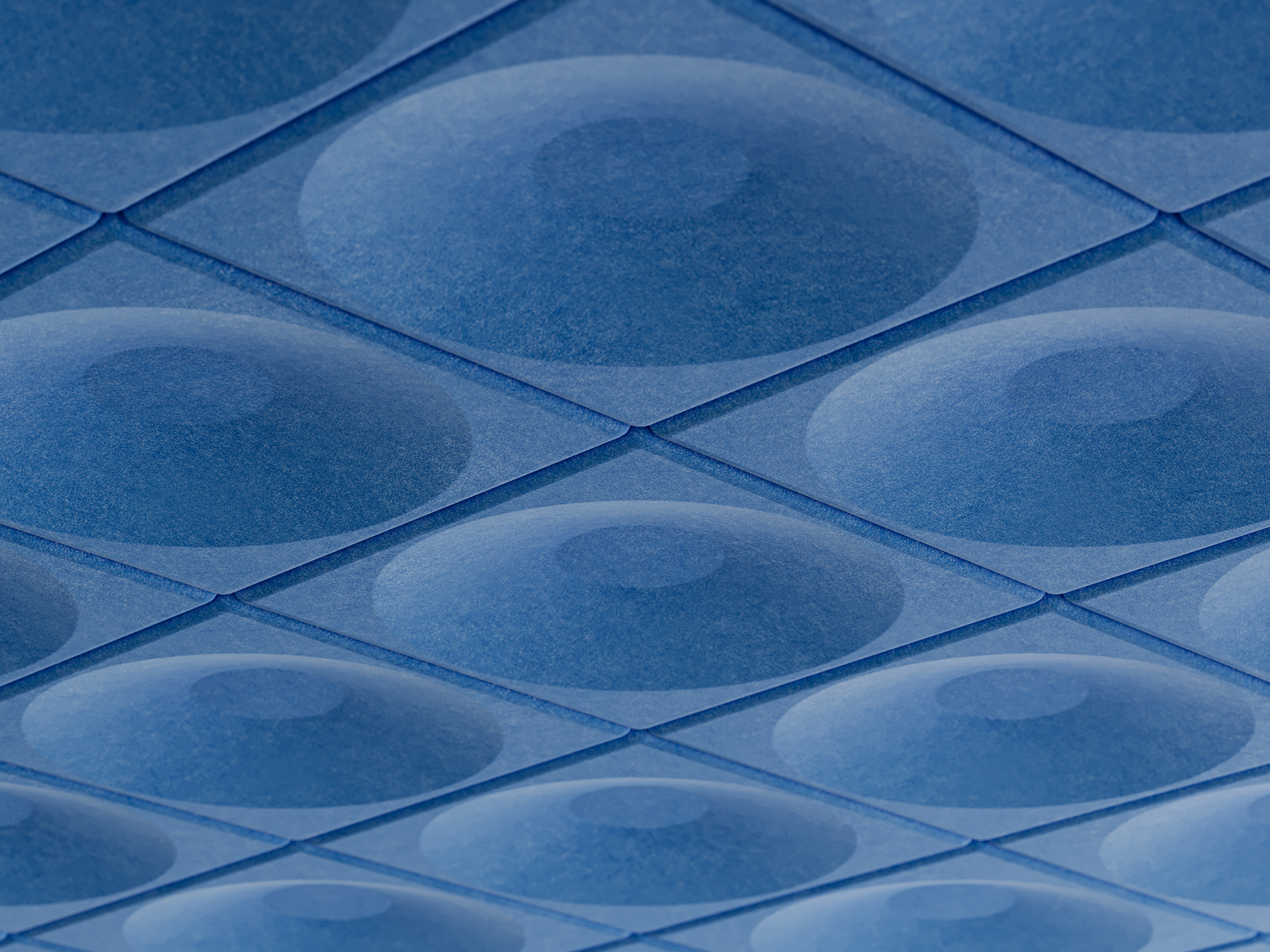 Close-up of a geometric acoustic felt ceiling pattern featuring blue, concave, circular shapes arranged in a grid, creating a three-dimensional, textured effect. The lighting highlights the depth and repetitive structure.