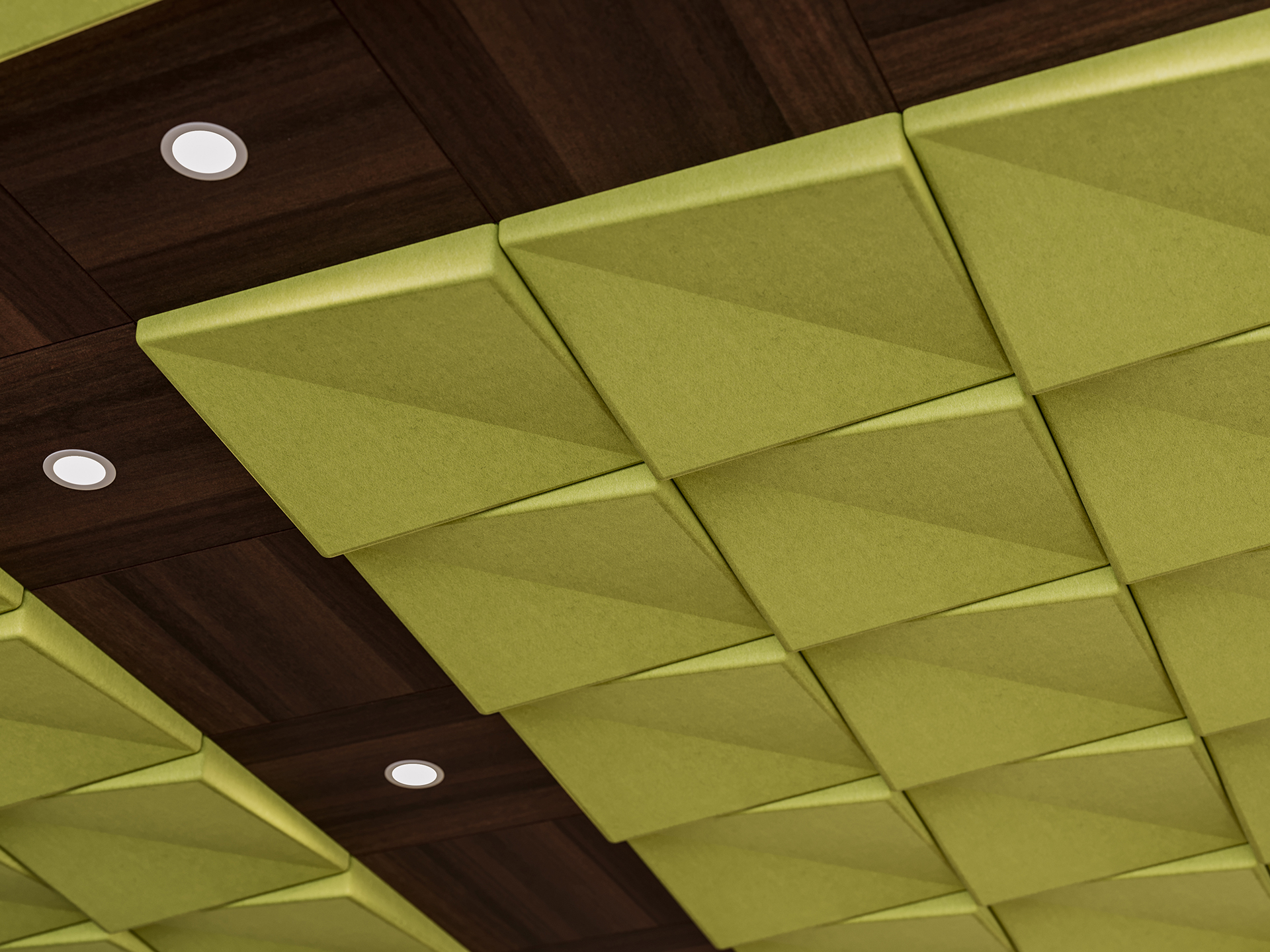 Ceiling with acoustic felt geometric panels in olive green and dark wood tones, featuring recessed round lights evenly spaced among the panels. The pattern creates a modern, textured look.