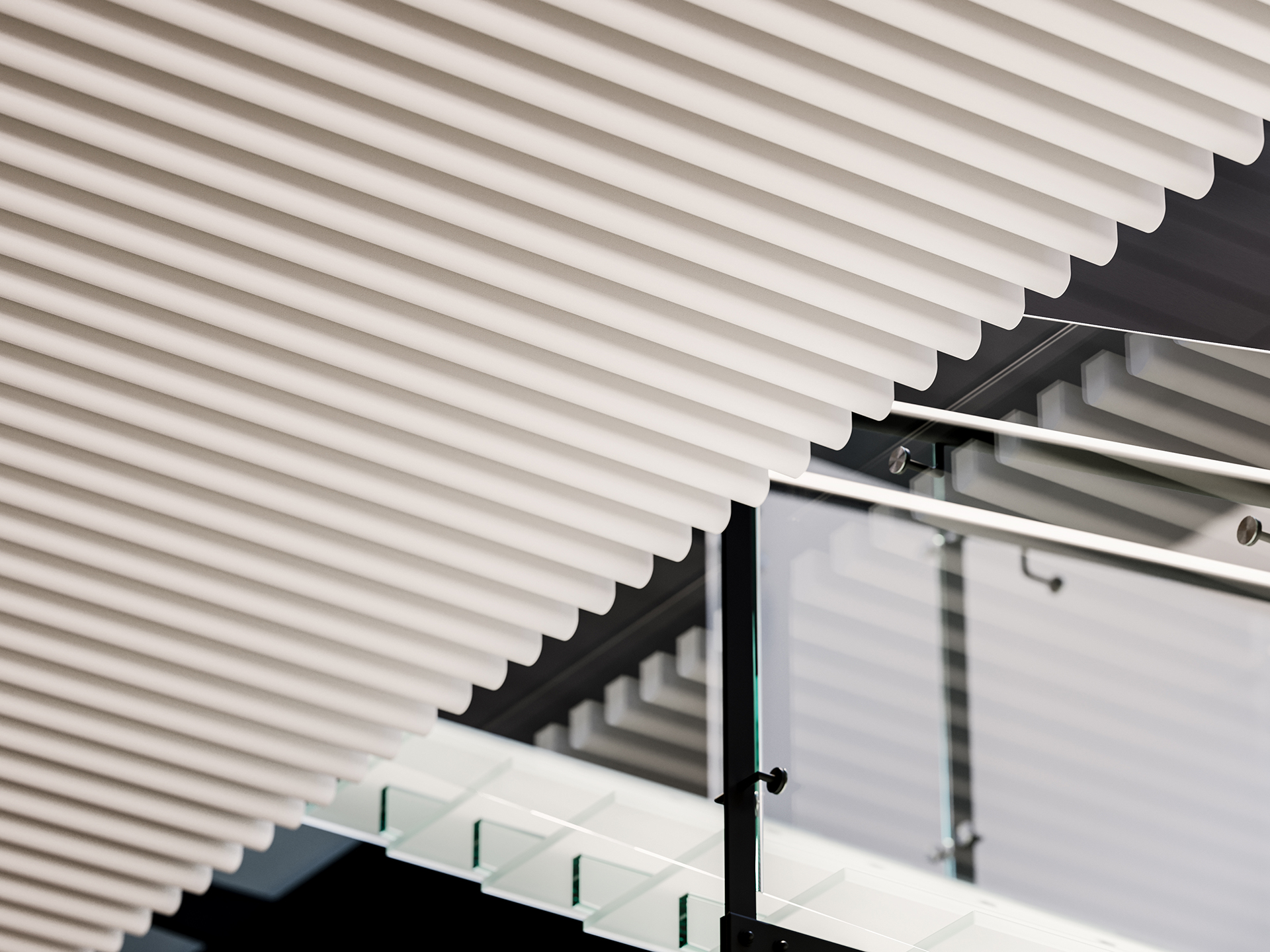 Close-up of a modern architectural ceiling with white, evenly spaced acoustic felt slats, a glass railing, and metal handrails, creating a geometric, abstract design with overlapping lines and shadows.