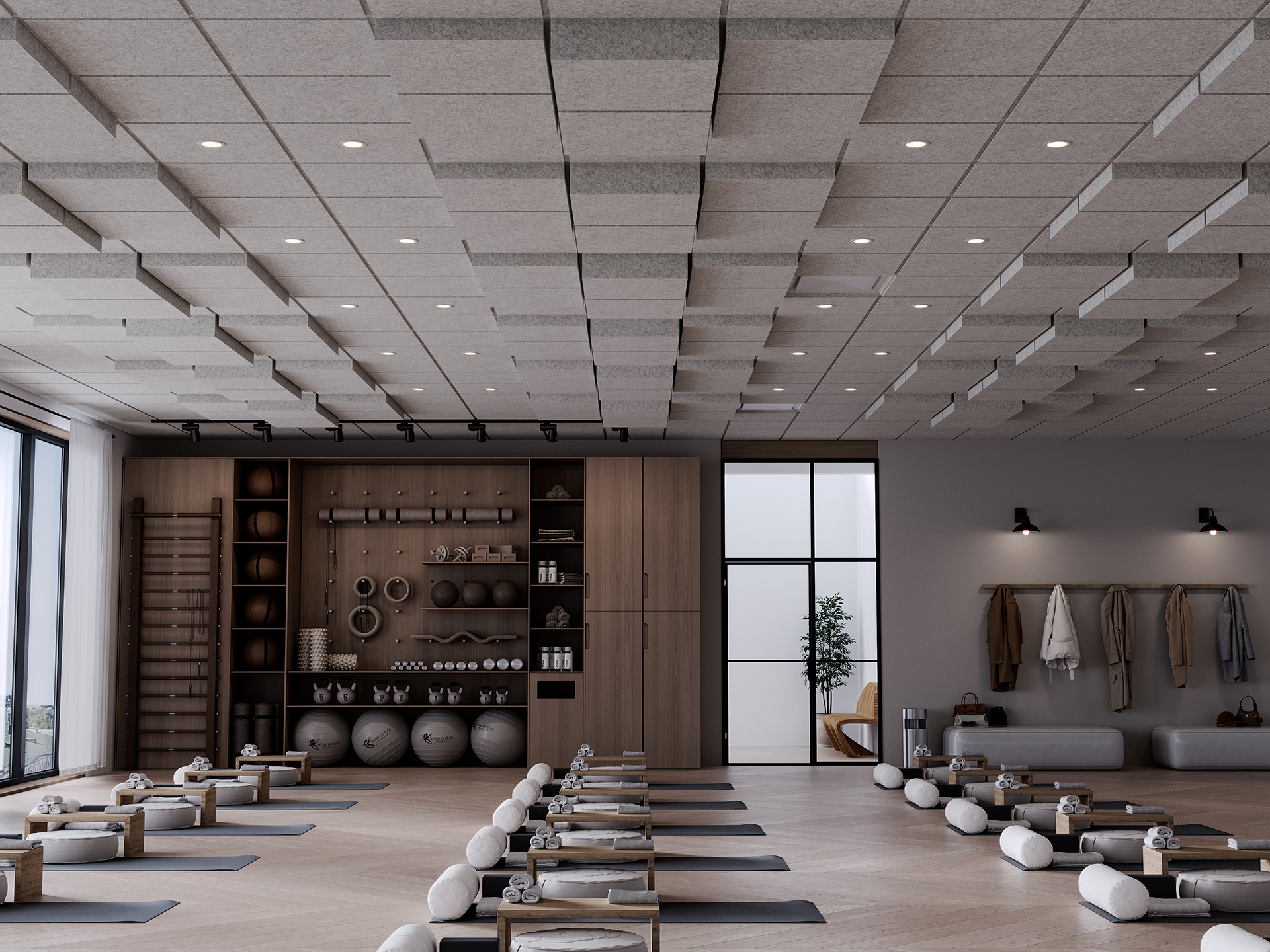 A modern yoga studio with mats, bolsters, and water bottles neatly arranged on the floor, wooden shelves with yoga props, large windows, and acoustic frames on the ceiling.