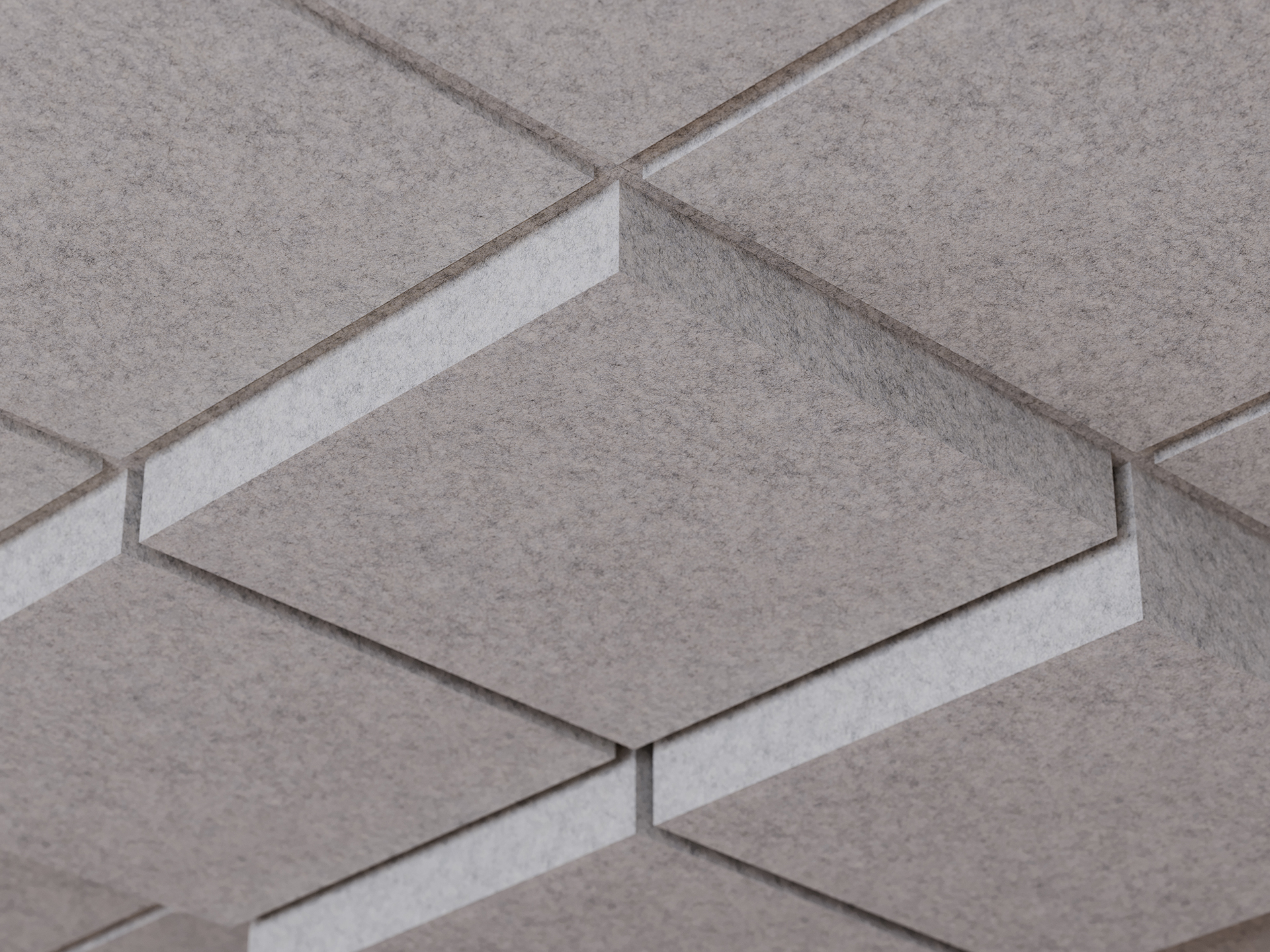 Gray acoustic ceiling tiles arranged in a geometric, diamond-shaped pattern with recessed edges, creating a three-dimensional, textured effect.