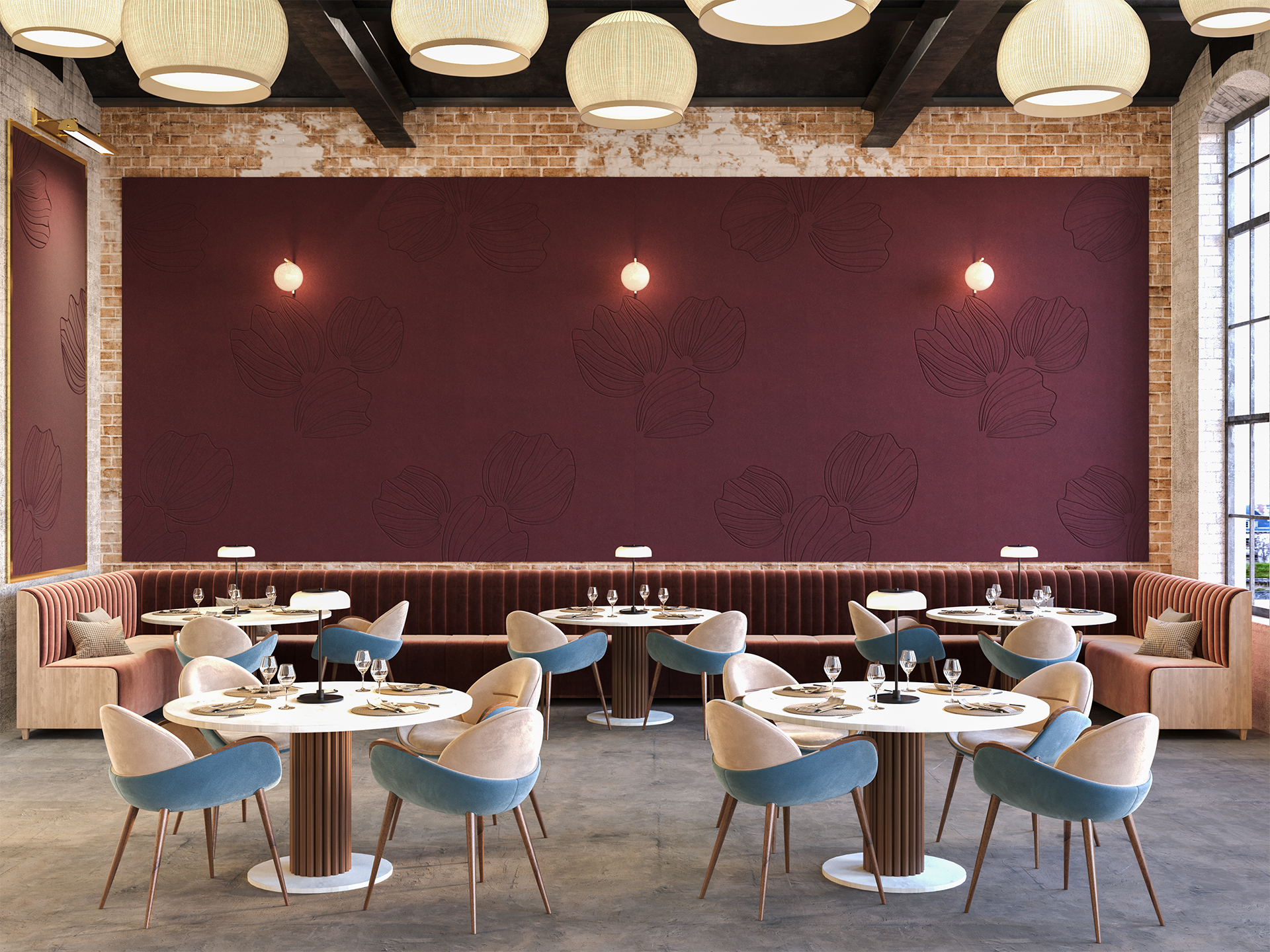 A modern restaurant interior with round tables, plush blue and beige chairs, a long upholstered booth, brick walls, large Loganberry acoustic felt accent wall, and hanging round lights. Daylight streams in from tall windows on the right.