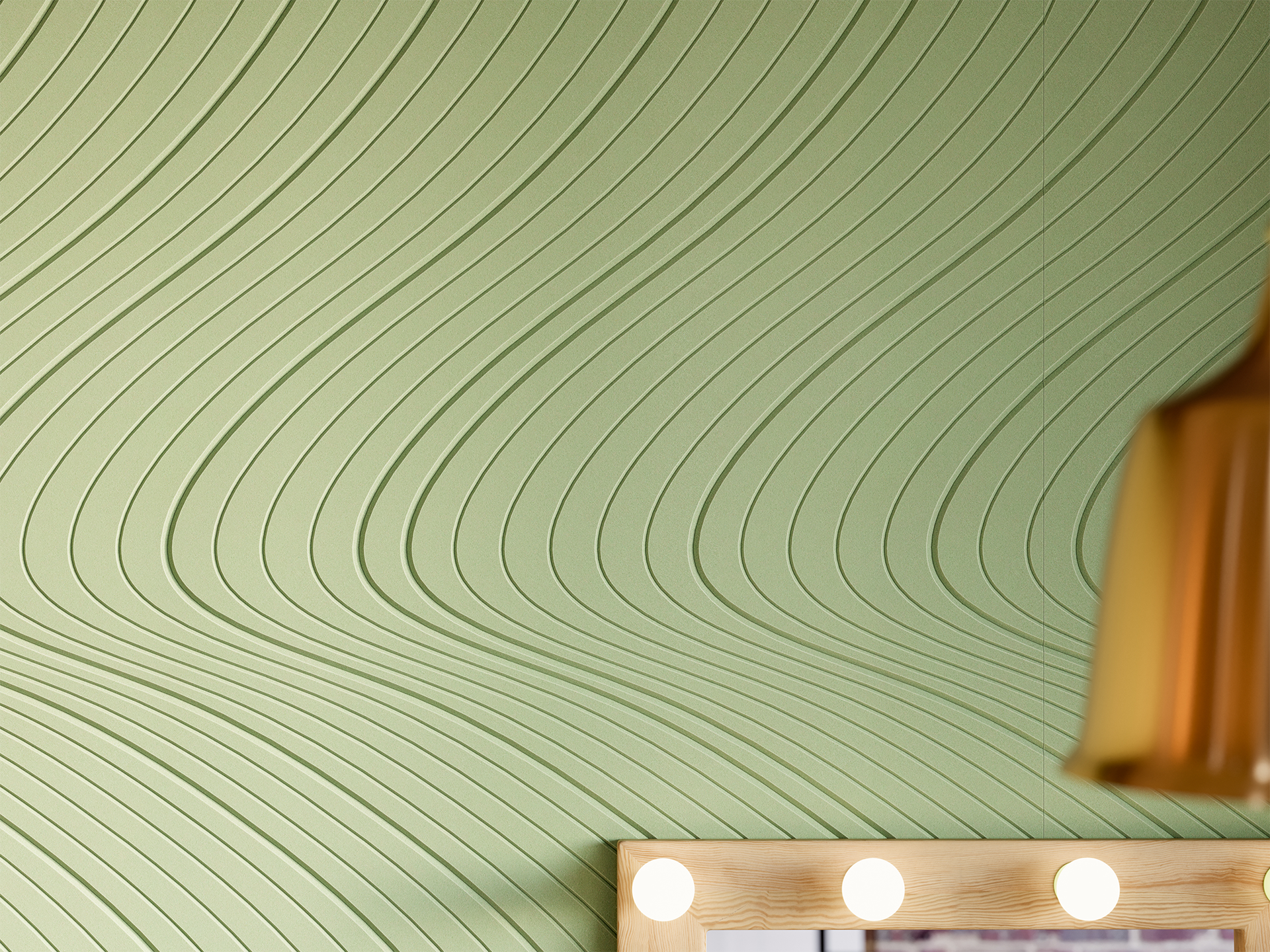 A green acoustic felt wall with a textured, wavy pattern. In the bottom right corner, part of a mirror with light bulbs and a brown lampshade is visible.